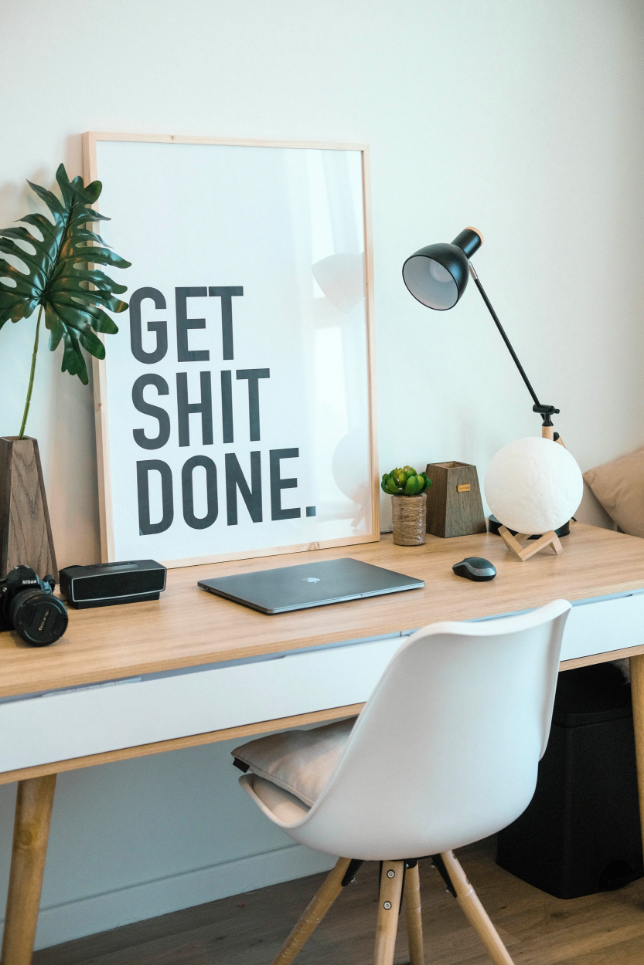 poster on a desk saying get shit done